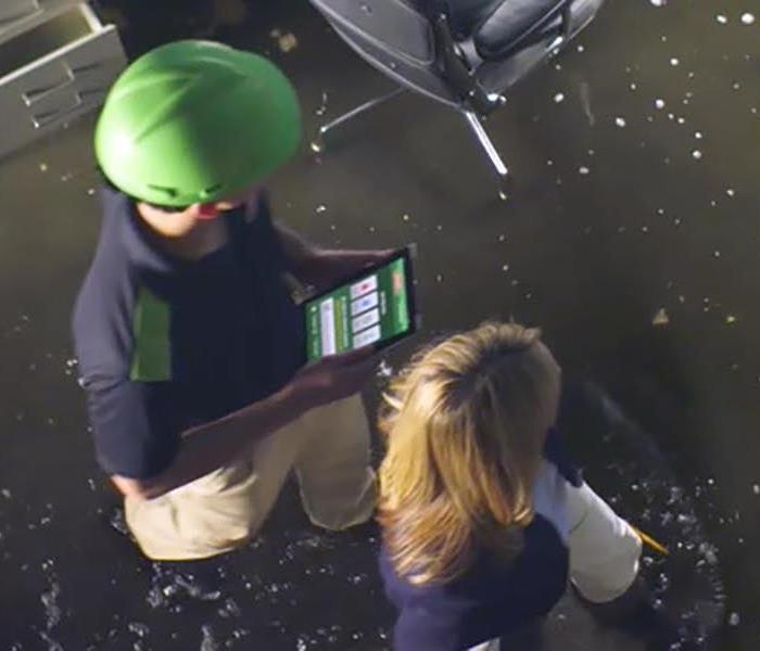 SERVPRO crew member at flooded property