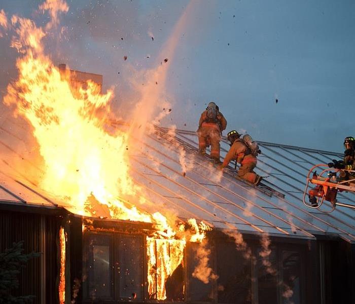 Firefighters on Roof of Home