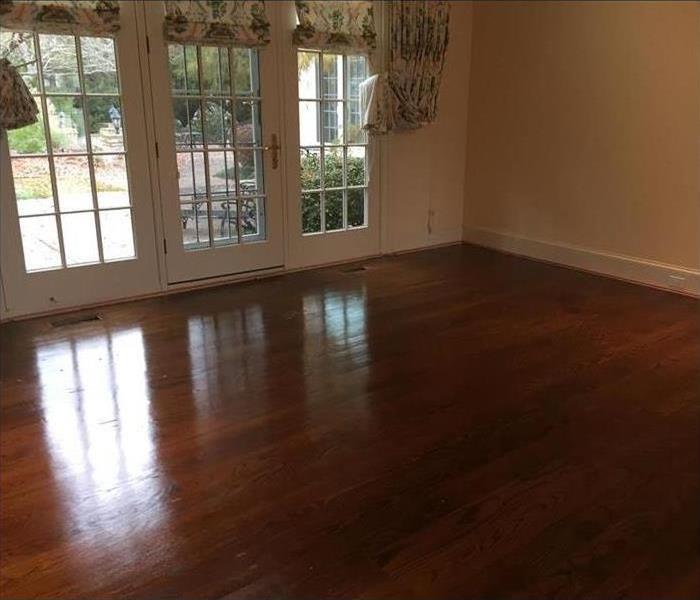 A clean living room with a shiny wood floor
