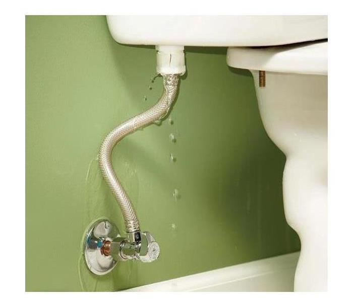 Water flows out of a burst pipe