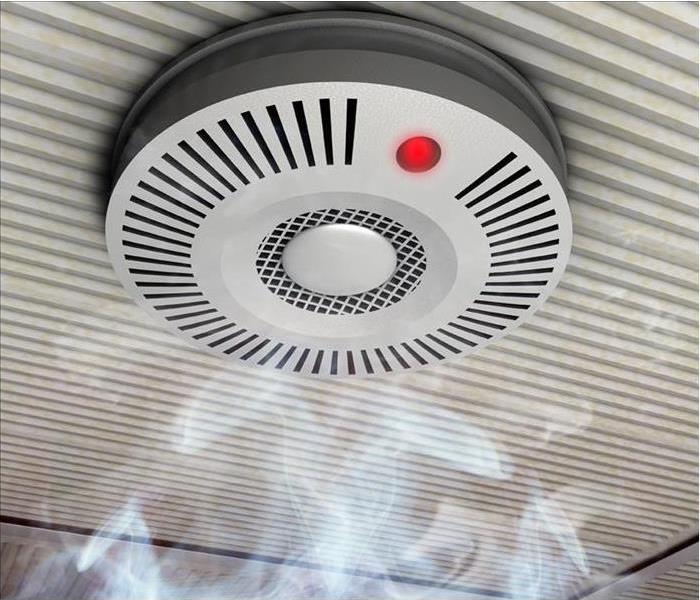 A smoke detector mounted on a ceiling